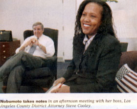 Nobumoto takes notes in an afternoon meeting with her boss, Los Angeles County District Attorney Steve Cooley.