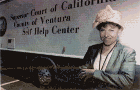 Tina Rasnow, director of Ventrua County's Self-Help Legal Access Center, stands by the center's 35-foot mobile home, which travels the county four days a week, bringing free legal information to those who need it. The bus is an innovative approach to providing pro pers access to the courts.