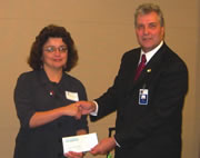 State Bar President Jim Herman presents Judith Escobedo of META with a check for $5,000.