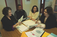 EPA CAN DO team confers on a case. They are (L-R) Shirley Hochhausen, executive director Robert Jones, Stanford law student Alexis Soterakis and program director Beatriz Rodriguez-Jraous.