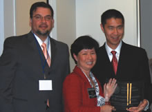 Luis Rodriguez (left) and Holly Fujie present a Diversity Award to Garner Weng.