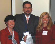 Holly Fujie (left)and Luis Rodriguez present a Diversity Award to Barbara Matthews.